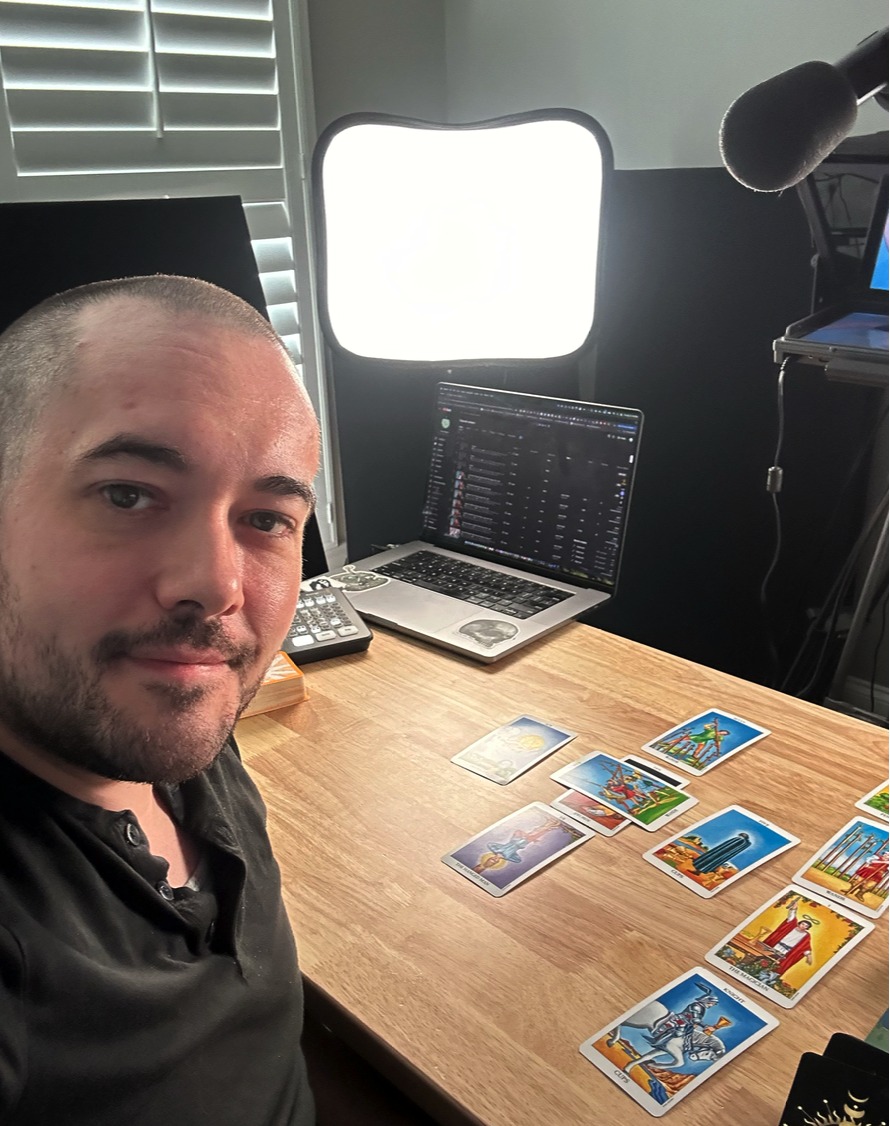 Chris Reck reading tarot at his desk