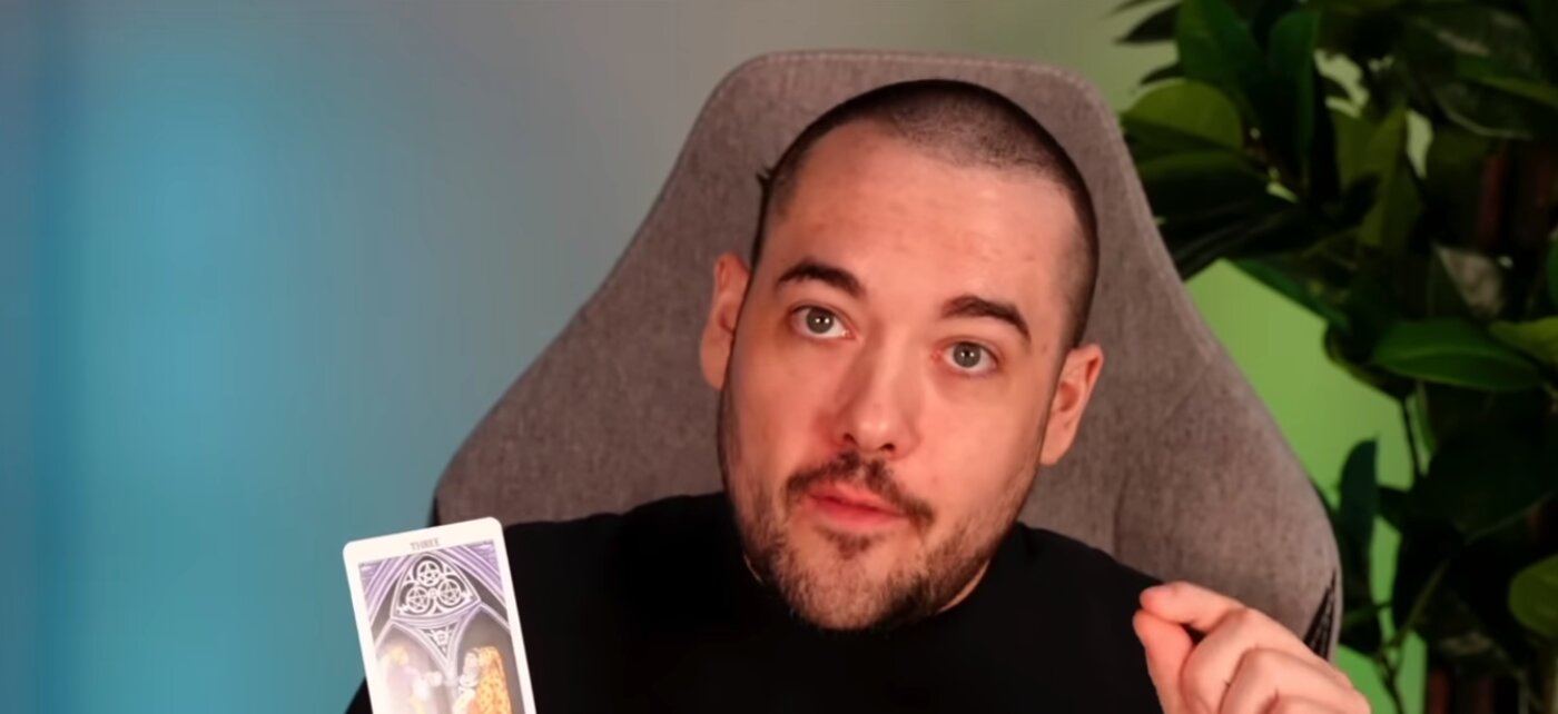 Chris Reck holding a tarot card during a reading